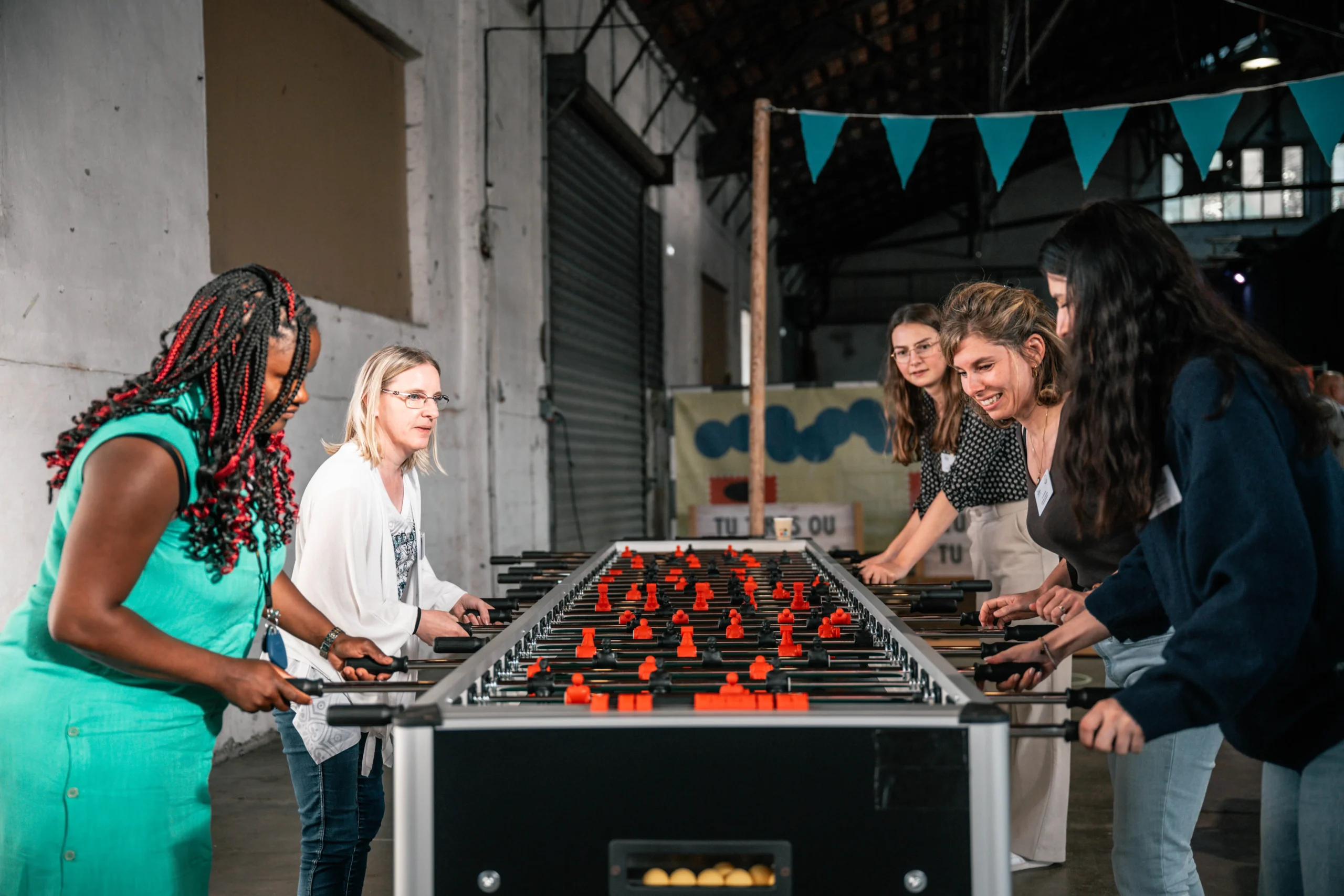Corporate foosball build Quebec workshop assembling wooden table by the river · INNOV'events event management