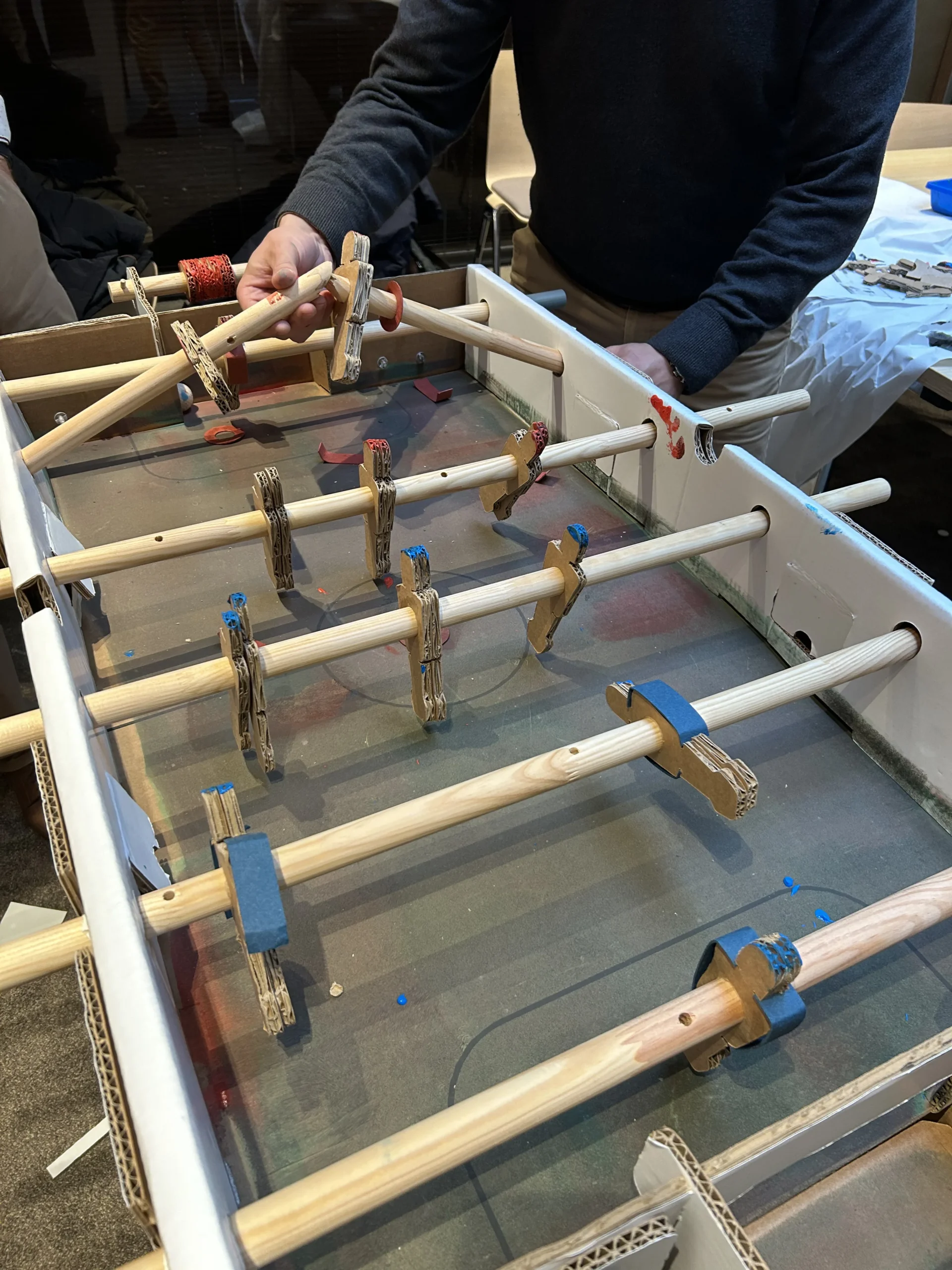 Foosball-building workshop Montreal teams at work in the Vieux-Port with a view of the St. Lawrence River · INNOV'events