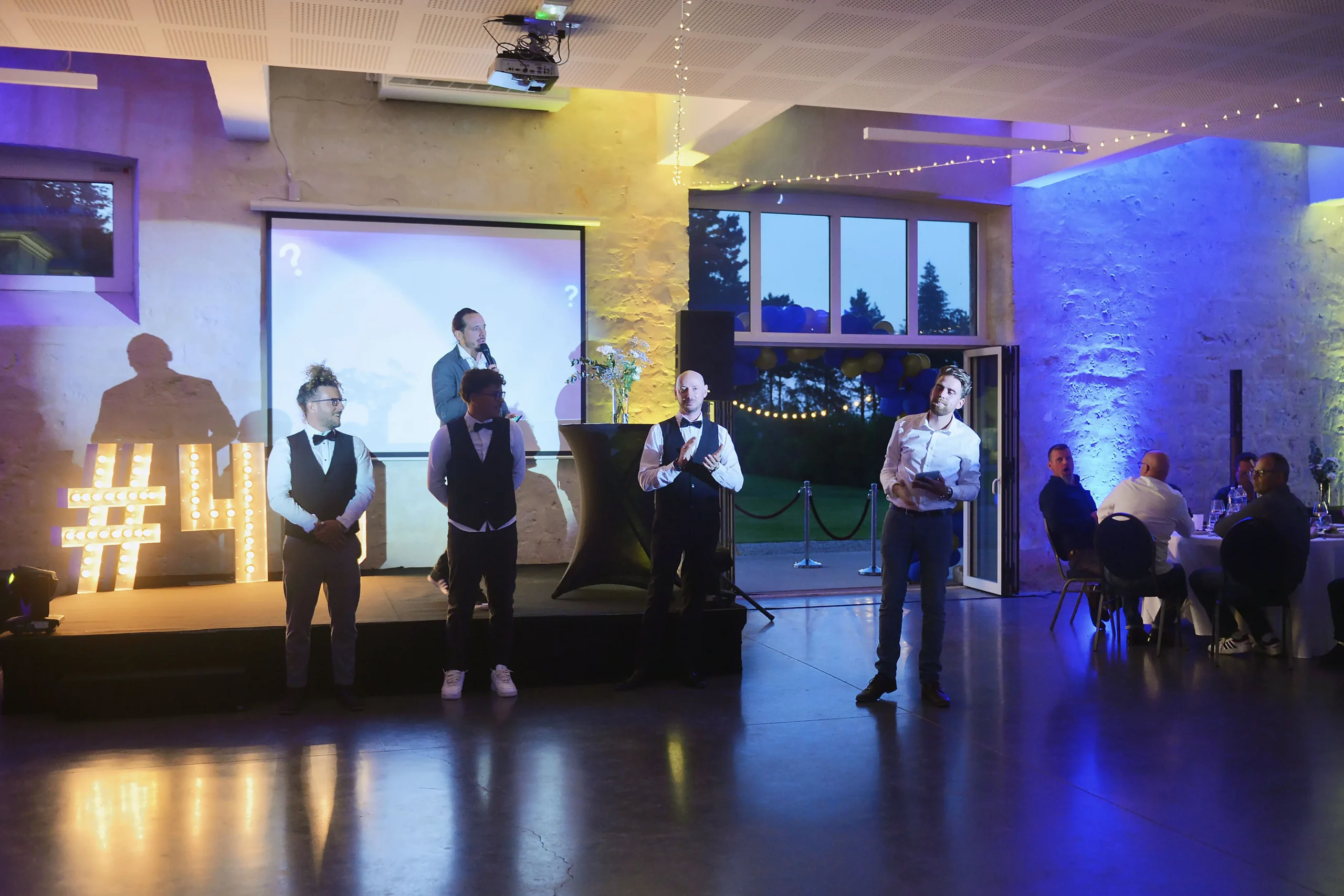 Photo booth entertainment farewell party Laval colleagues in front of corporate backdrop evening · INNOV'events