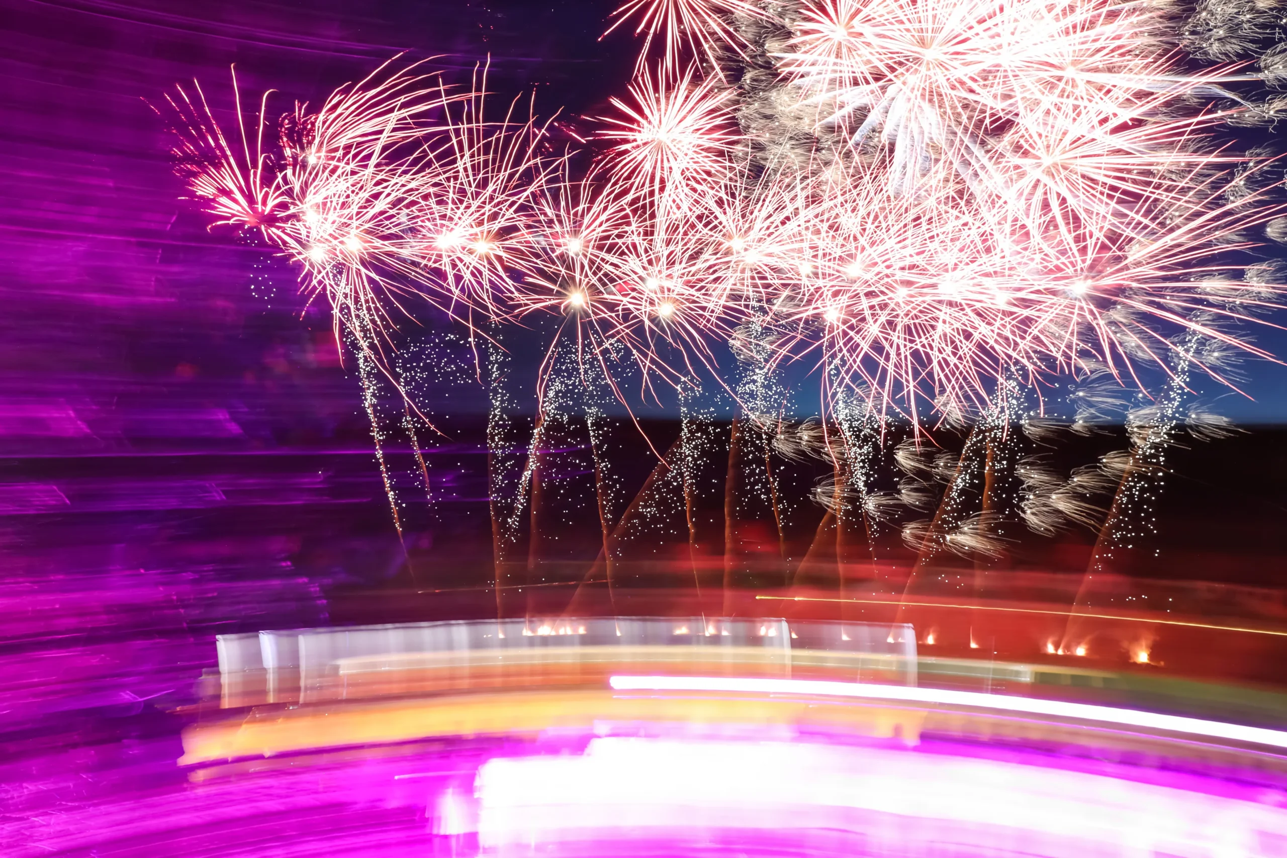 Corporate fireworks in Laval, illuminated riverbank with employee groups · INNOV'events